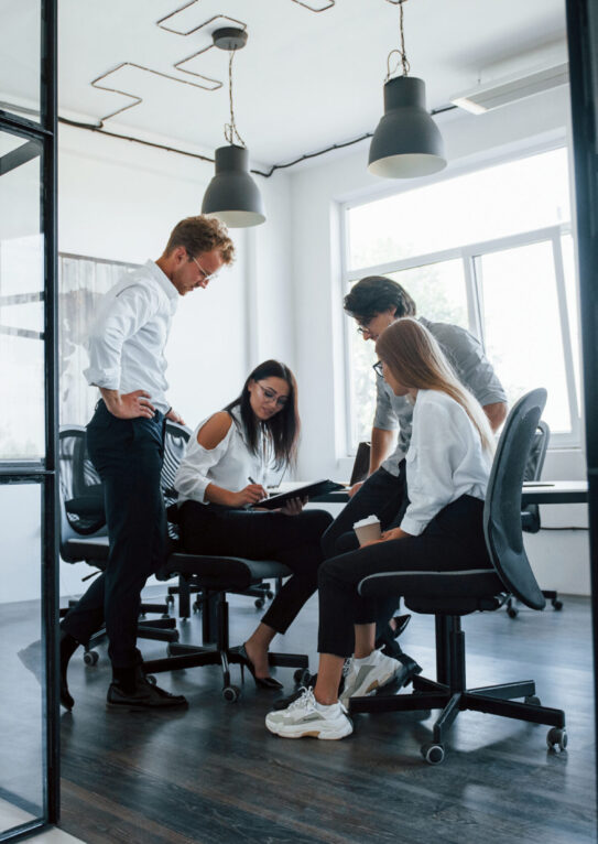 Active conversation. Young business people in formal clothes working in the office.