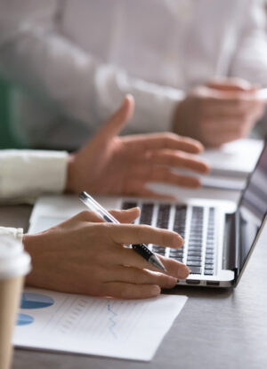 Businesswoman using laptop presenting project statistics report or market analysis at meeting, making offer or financial forecast, consulting clients, discussing work or negotiating, close up view