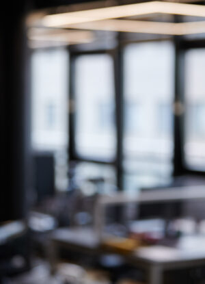 Modern office blurred background. Large corporation workplaces in open space office. Soft focus